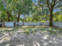 Spacious backyard with a storage shed and a white brick fence, perfect for outdoor activities at 2109 Hartwell Ave, Sanford, FL 32771
