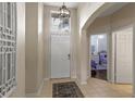 Inviting foyer with tile flooring, high ceilings, and natural light, leading to an open floor plan at 2222 Wyndham Palms Way, Kissimmee, FL 34747