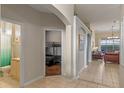 Spacious hallway with arched doorways, tile flooring, and views of the living area and bedrooms at 2222 Wyndham Palms Way, Kissimmee, FL 34747