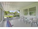 Inviting screened porch with seating area and a hammock for relaxing outdoors at 224 Woodmere Blvd, Sanford, FL 32773