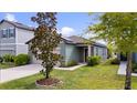 Single Gathering home showing solar panels and manicured lawn with bark at 2249 Litchfield Loop, Deland, FL 32720