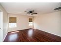Well-lit bedroom features hardwood floors, ceiling fan and two windows at 2337 Bexley Pl, Casselberry, FL 32707