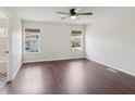 Bright bedroom with wood floors, ceiling fan, and natural light from two windows at 2337 Bexley Pl, Casselberry, FL 32707