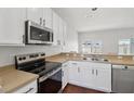 Well-lit kitchen with stainless steel appliances and ample countertop space for cooking at 2337 Bexley Pl, Casselberry, FL 32707