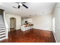 Spacious living room with hardwood floors, recessed lighting, and bar seating area at 2337 Bexley Pl, Casselberry, FL 32707
