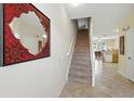 Hallway with staircase and view to kitchen at 2409 Silver Palm Dr, Kissimmee, FL 34747