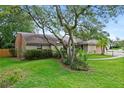 Well-maintained home featuring mature trees and lush greenery creating a serene setting at 283 Haverclub Ct, Longwood, FL 32779