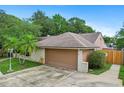 Spacious garage with a clean, well-kept driveway and landscaping at 283 Haverclub Ct, Longwood, FL 32779