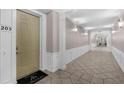 Hallway featuring tiled floors, chair rail moulding, and neutral paint at 4804 Cayview Ave # 20512, Orlando, FL 32819
