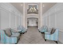 Elegant lobby featuring comfortable seating, tiled floors, and a stunning chandelier at 4804 Cayview Ave # 20512, Orlando, FL 32819
