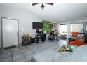 Cozy living room with tile floors, sliding glass doors, and ample natural light at 5027 Vineland Rd # 5027, Orlando, FL 32811