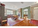 Elegant dining room with stone fireplace, hardwood floors, and ample natural light at 513 Legacy Park Dr, Casselberry, FL 32707