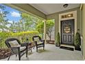 Welcoming front porch with seating and a decorative door at 513 Legacy Park Dr, Casselberry, FL 32707