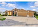 Charming home featuring a three-car garage and lush landscaping at 5339 Pond Crossing Pl, Leesburg, FL 34748