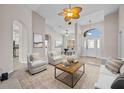Bright living room with high ceilings, neutral colors, and archways to other rooms at 5339 Pond Crossing Pl, Leesburg, FL 34748