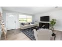 Living room features a white couch, and a dark wood entertainment center at 692 Gaslight Dr, South Daytona, FL 32119
