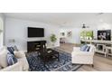 Bright living room with white furniture, a large rug, and an open floor plan at 692 Gaslight Dr, South Daytona, FL 32119
