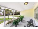 Screened porch featuring neutral colored walls, a brick foundation, and outdoor furniture at 692 Gaslight Dr, South Daytona, FL 32119