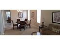 Open dining area with a round table, six chairs, and modern decor, illuminated by a chandelier at 844 Suffolk Pl, Davenport, FL 33896