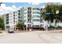 Condominium building with balconies in urban area, lush landscaping and commercial space for easy access to amenities at 10 N Summerlin Ave # 14, Orlando, FL 32801
