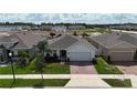 Charming single-Gathering home in a quiet neighborhood with lush landscaping and manicured lawn at 165 Lavenna Ave, St Cloud, FL 34771