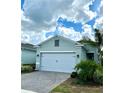 Charming single-Gathering home featuring lush landscaping, a paver driveway, and a two-car garage at 2042 Key Bay Trl, Kissimmee, FL 34747