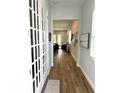 Inviting home hallway featuring wood flooring and a charming view leading to the living room at 2042 Key Bay Trl, Kissimmee, FL 34747