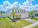 A beautiful two-story home with a well-maintained lawn and a two-car garage in a sunny neighborhood at 2149 Tudor Rose Dr, Sanford, FL 32773