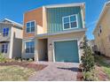 Stylish two-story home with vibrant siding, one-car garage and meticulously landscaped front yard at 2665 Petition Ln, Kissimmee, FL 34746