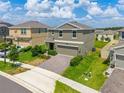 Spacious two-story home with brick driveway and landscaping situated in a residential neighborhood at 2817 Muller Oak Loop, Ocoee, FL 34761