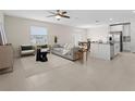 Bright and airy living room with modern furnishings and an open floor plan with easy kitchen access at 2817 Muller Oak Loop, Ocoee, FL 34761