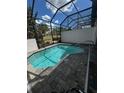 Relaxing in-ground pool surrounded by a screened enclosure perfect for outdoor enjoyment at 306 Captiva Dr, Davenport, FL 33896