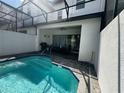 Enjoy the in-ground pool with a screened lanai and outdoor seating area at 306 Captiva Dr, Davenport, FL 33896