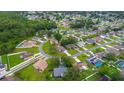 Aerial view of a residential area featuring well-manicured lawns and tree-lined streets at 339 Colony Ct, Kissimmee, FL 34758
