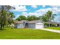 Charming single-story home with well-maintained lawn and attached two car garage on a sunny day at 339 Colony Ct, Kissimmee, FL 34758