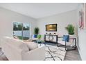 Bright living room with modern decor, stylish furniture, and sliding glass doors to the outdoors at 3408 Curlew Ave, Leesburg, FL 34748