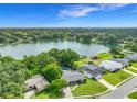 Breathtaking aerial view of the property with a lake view, surrounded by lush landscaping and mature trees at 3417 Pershing Ave, Orlando, FL 32812