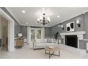 Bright living room showcasing fireplace, neutral paint, recessed lighting, tile flooring, and French doors at 3417 Pershing Ave, Orlando, FL 32812