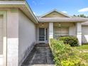 Welcoming front entrance with covered porch and manicured shrubbery providing curb appeal at 5409 Holtland Dr, Apopka, FL 32712