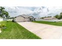 New home with long driveway and green lawn at 5908 Sw 115 Street Rd, Ocala, FL 34476