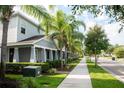 Pleasant street view highlighting sidewalk, manicured lawns, landscaping and inviting home exteriors at 5963 Glory Bower Dr, Winter Garden, FL 34787