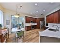 Spacious kitchen featuring custom wood cabinets, stainless steel appliances, and elegant countertop, ideal for cooking at 604 Timberwilde Ct, Winter Springs, FL 32708