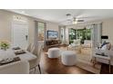 Bright living room with hardwood floors, modern furnishings, and sliding glass doors to the lanai at 6874 Slaven Dr, Orlando, FL 32819