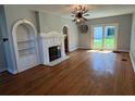 Spacious living room featuring hardwood floors, fireplace, and sliding door access to the backyard at 714 Springdale Rd, Orlando, FL 32804