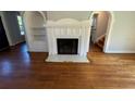 The inviting living room showcases a fireplace with hardwood flooring and is ready for your design touches at 714 Springdale Rd, Orlando, FL 32804
