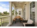 Covered balcony with ceiling fan featuring wooden table and seating perfect for enjoying outdoor meals and relaxing at 7509 Mourning Dove Cir # 204, Reunion, FL 34747
