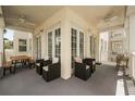 Expansive wrap-around covered balcony with ceiling fans and comfortable seating areas for relaxing and entertaining at 7509 Mourning Dove Cir # 204, Reunion, FL 34747