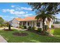 Well-maintained home with a lush lawn, mature landscaping, and inviting covered front porch at 930 Willow Oak Loop, Minneola, FL 34715