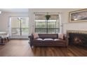 Comfortable living room with hardwood floors, fireplace, and natural light at 940 Douglas Ave # 159, Altamonte Springs, FL 32714