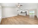 Inviting living room with vaulted ceilings and an open floor plan leading to the kitchen at 1059 Ne 130Th Ter, Silver Springs, FL 34488
